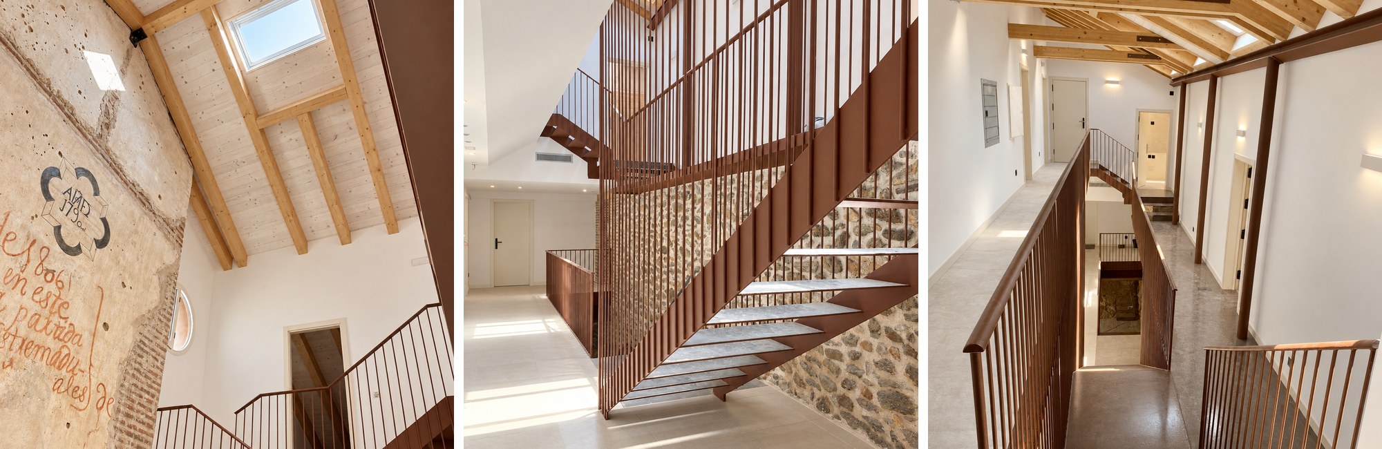 El Esquileo: muro histórico con inscripciones y lucernario en cubierta de madera, escalera de acero corten junto a muro de piedra y pasillo con barandilla corten – Erades Arquitectos