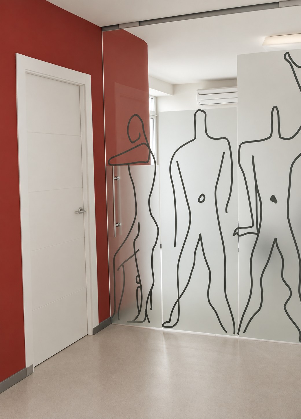 Estudio ERD Arquitectos en Madrid: puerta granate y mamparas de vidrio con figuras serigrafiadas